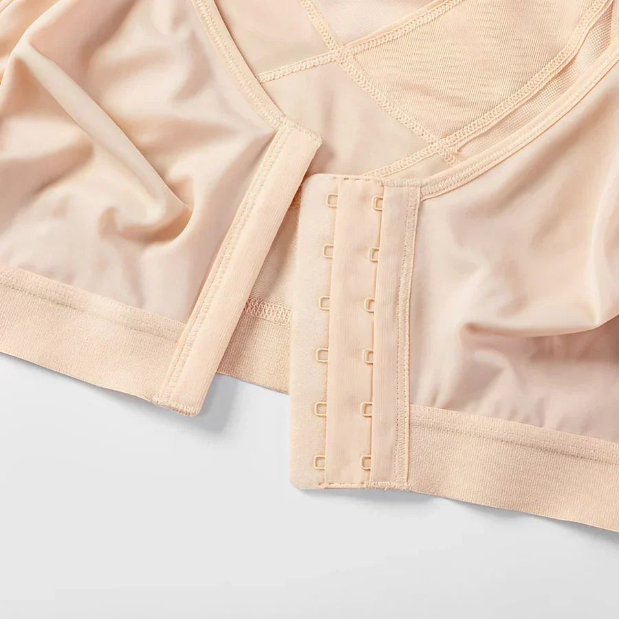 Reggiseno post-operatorio beige con chiusura frontale a ganci, tessuto morbido e traspirante, ideale per comfort e supporto post-chirurgico.