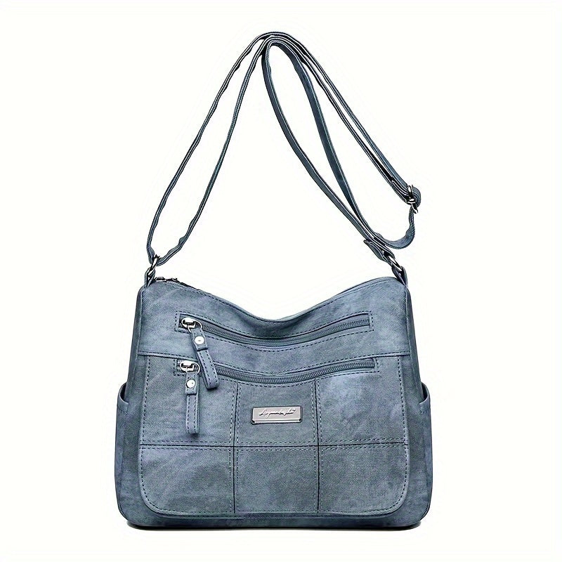 Borsa a tracolla in pelle scamosciata blu, design elegante con tasche frontali e chiusura a zip, ideale per moda donna e accessori di tendenza.