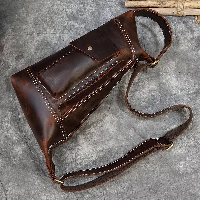 Borsa a tracolla in pelle marrone vintage, design elegante con tasca frontale e cuciture bianche, ideale per uomo, accessorio moda casual.