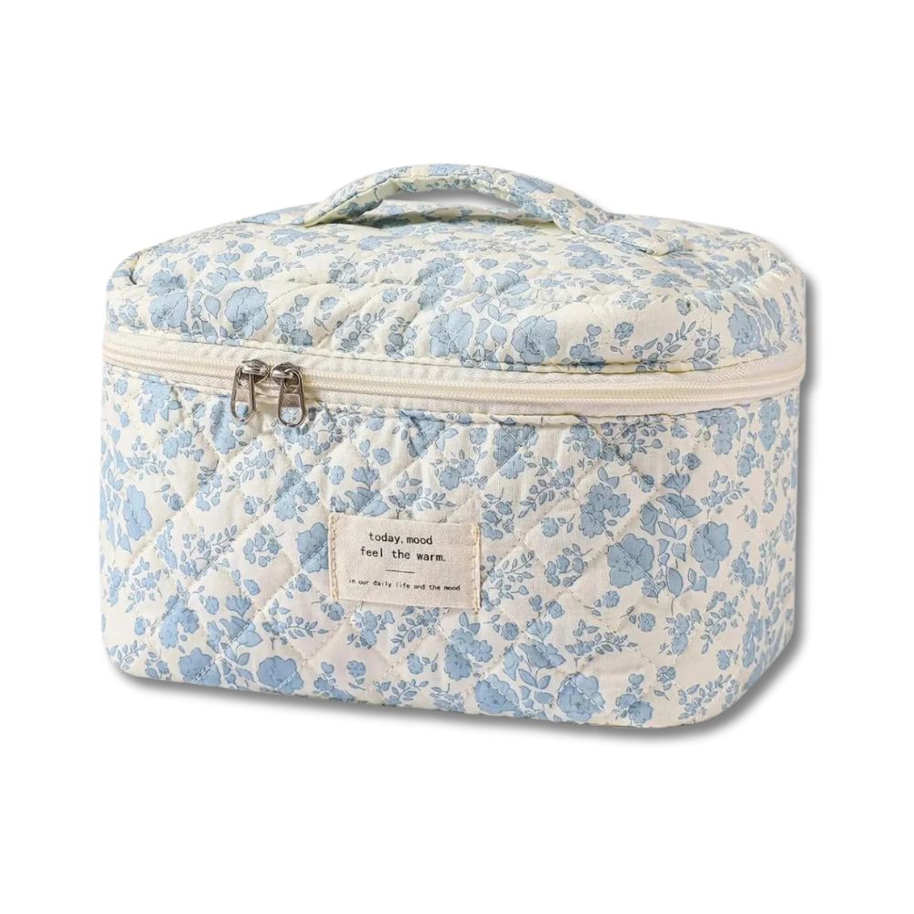 Borsa termica floreale bianca e blu con cerniera e manico, ideale per picnic e viaggi. Design elegante e pratico per conservare cibi e bevande.