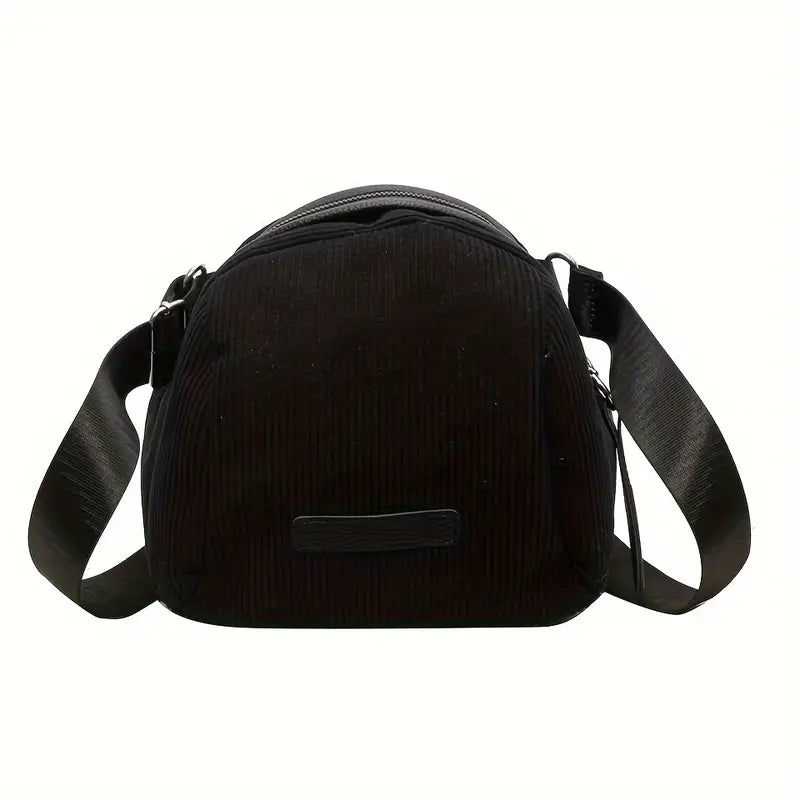 Borsa a tracolla nera in tessuto a coste, design moderno, chiusura con zip, ideale per uso quotidiano. Accessorio moda donna elegante e pratico.