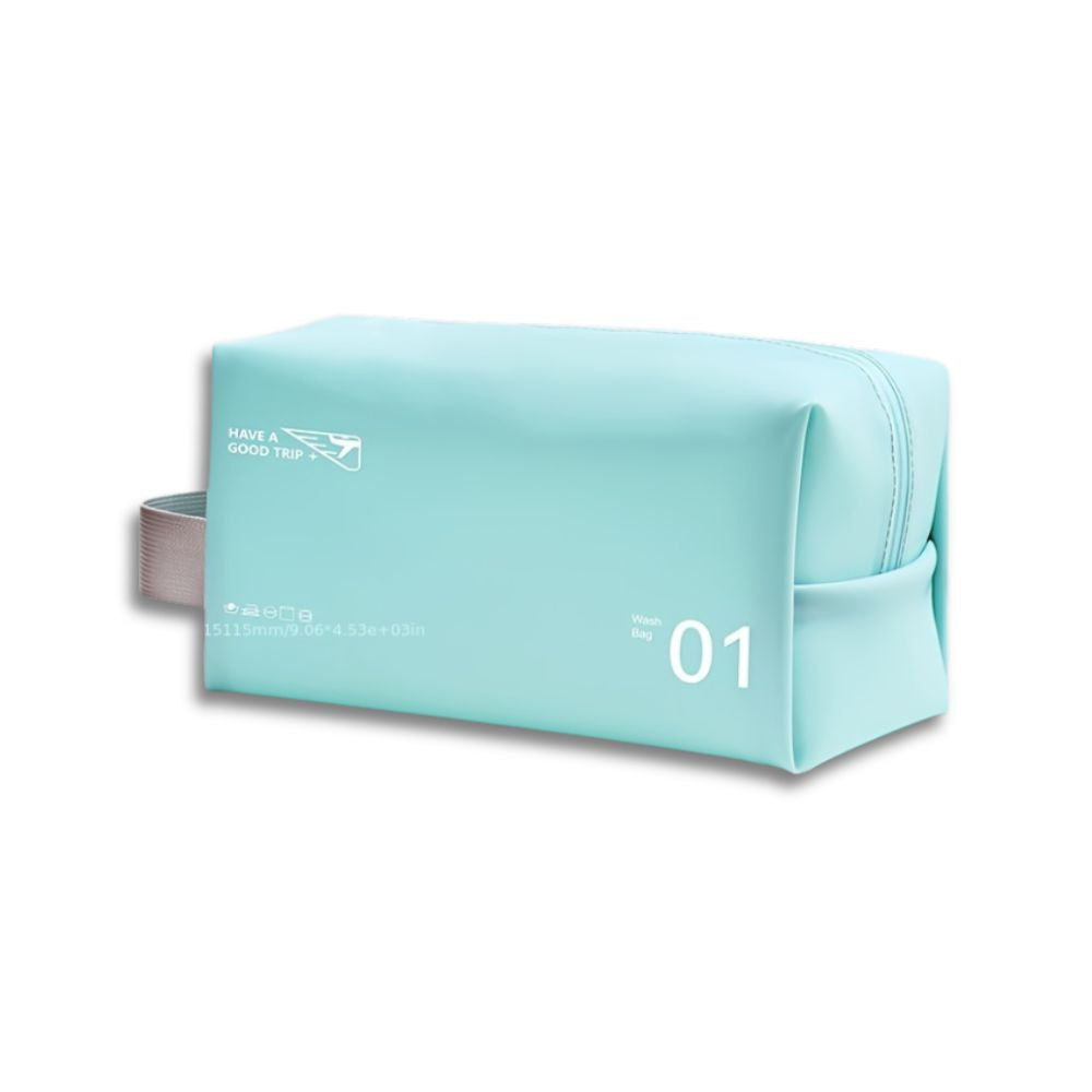 Astuccio da viaggio azzurro con cerniera, manico laterale e scritta "Have a Good Trip". Design moderno, ideale per cosmetici e accessori.