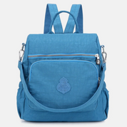 Zaino donna blu in nylon impermeabile, con tasca frontale con zip, spallacci regolabili e manico superiore. Ideale per viaggi e uso quotidiano.