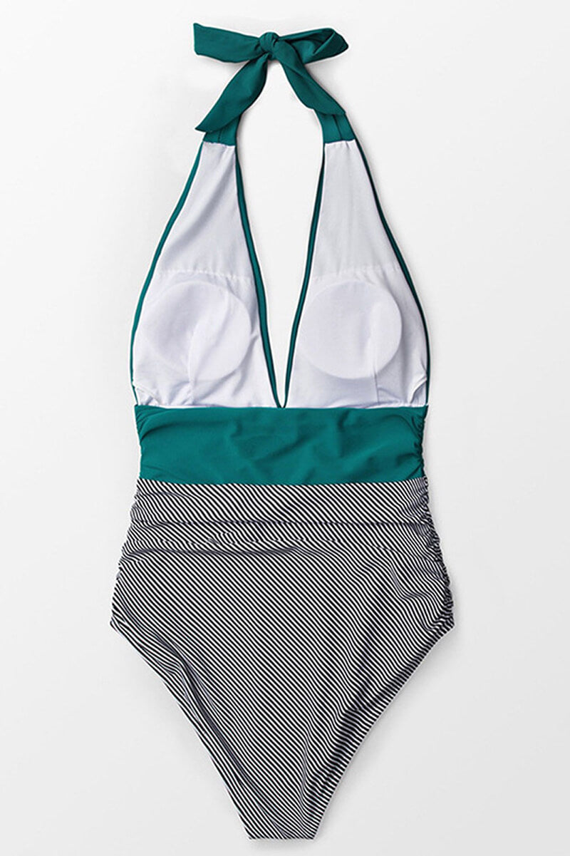 Costume intero donna a righe bianche e nere, scollo profondo, con dettagli verde acqua. Elegante e alla moda per l'estate.