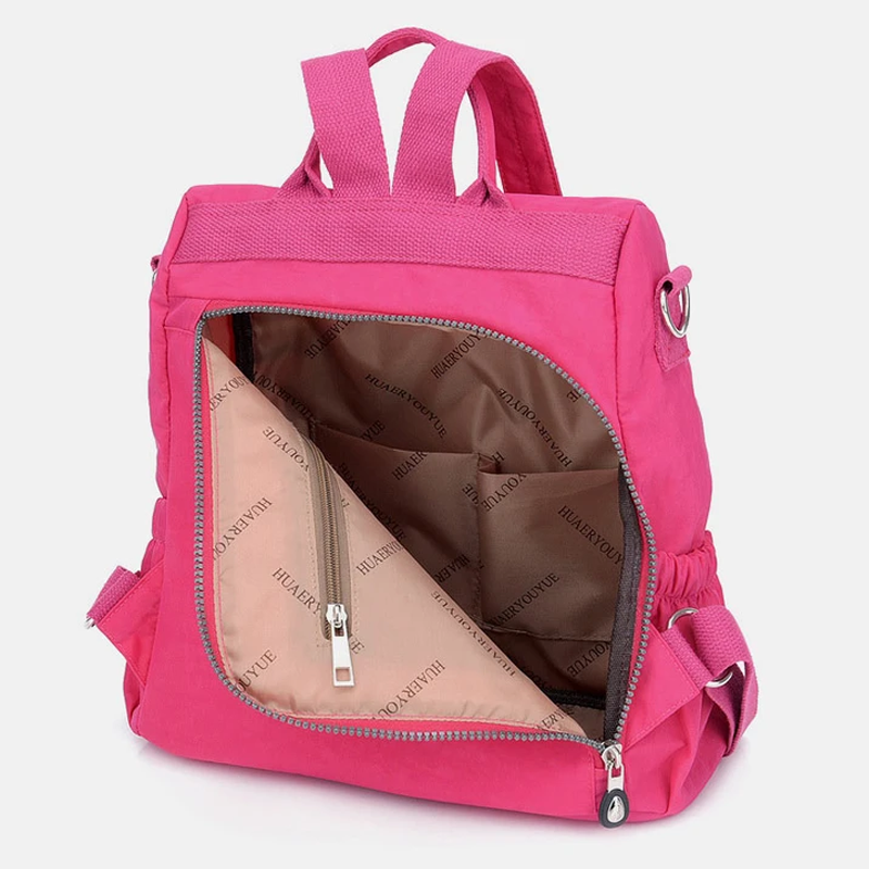Zaino rosa aperto con tasca interna visibile, design moderno, tessuto resistente, ideale per scuola e viaggio. Accessorio moda funzionale.