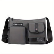 Borsa a tracolla grigia impermeabile con tasche multiple, design moderno, ideale per uomo e donna, perfetta per viaggi e uso quotidiano.