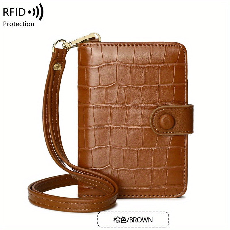 Portafoglio in pelle marrone con texture coccodrillo, cinturino da polso e protezione RFID. Elegante e sicuro per carte e contanti.