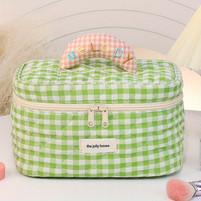 Astuccio cosmetico verde a quadretti con manico imbottito "Melody", cerniera e marchio "the jolly house". Ideale per trucco e accessori.