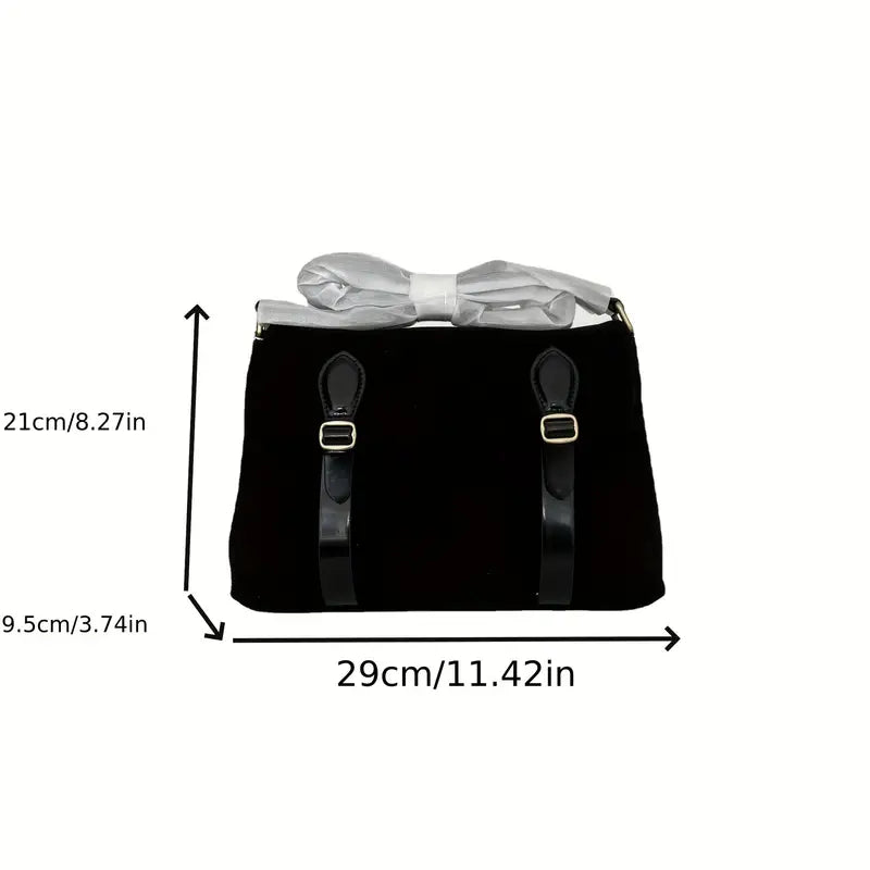 Borsa a mano nera in velluto con dettagli in pelle, fiocco bianco decorativo, dimensioni 29x21x9.5 cm. Elegante accessorio moda donna.