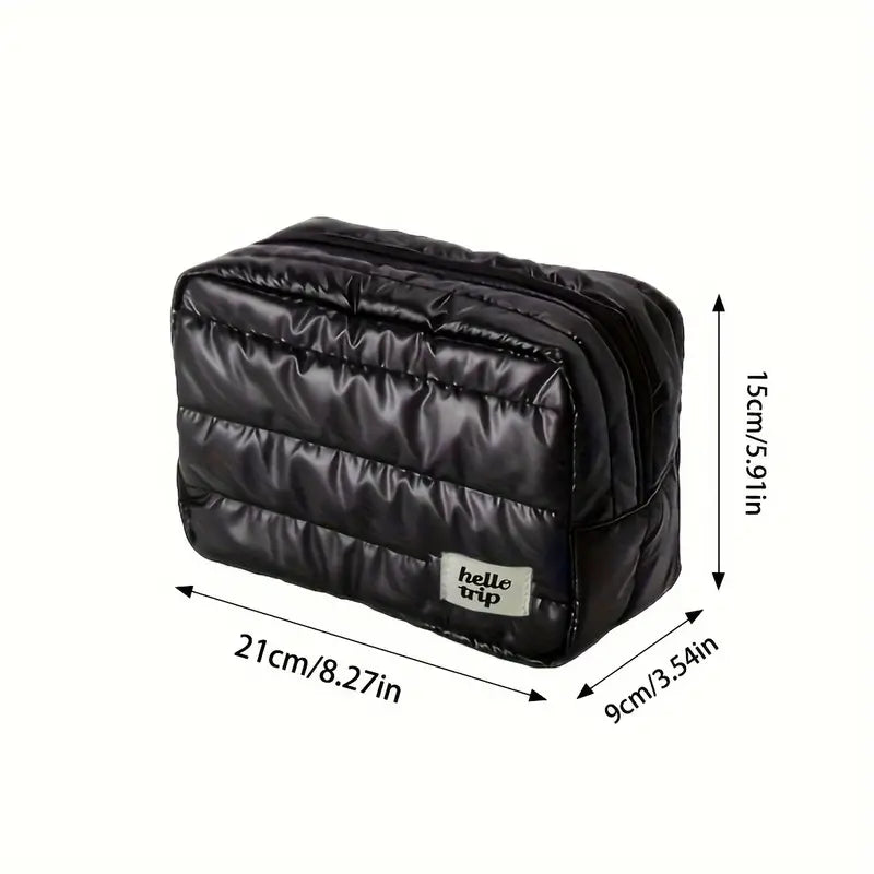 Borsa da viaggio nera imbottita, dimensioni 21x9x15 cm, ideale per organizzare accessori. Design compatto e resistente, perfetto per viaggi.