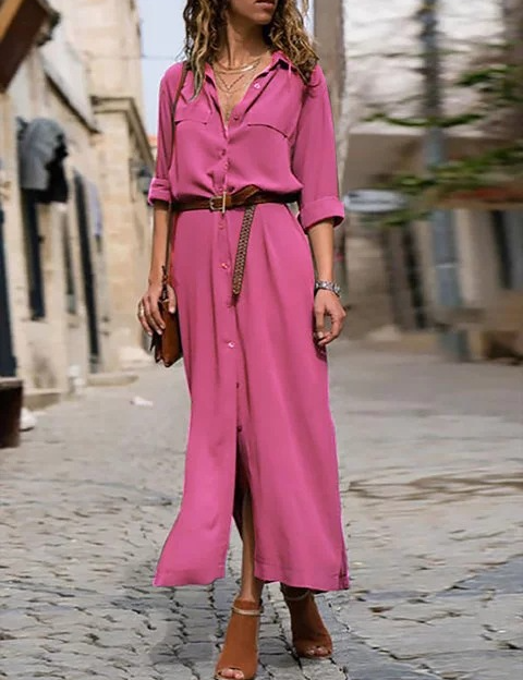 Donna con abito lungo rosa, cintura marrone, sandali aperti, cammina su strada acciottolata. Moda casual, abbigliamento estivo, stile urbano.