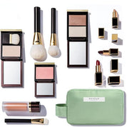 Set di trucchi di lusso con pennelli, rossetti, cipria, blush e pochette verde. Prodotti cosmetici eleganti per un look professionale.
