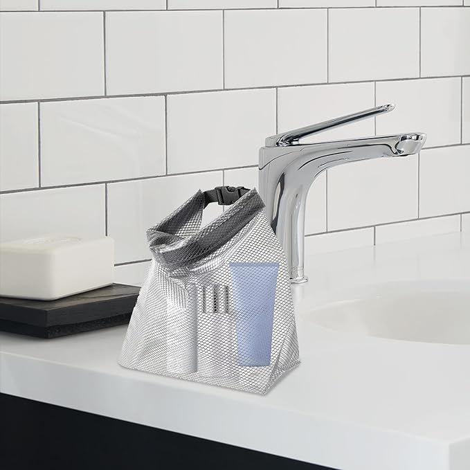 Borsa da toilette trasparente su lavandino bagno moderno, contenente flaconi cosmetici. Ideale per viaggi, organizzazione prodotti bellezza.