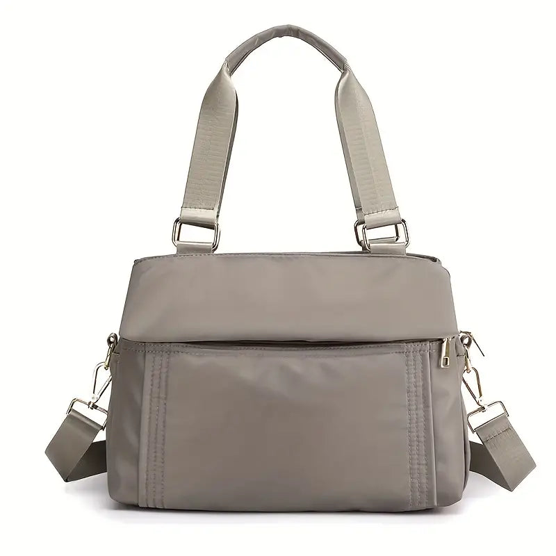 Borsa a tracolla grigia in nylon impermeabile con tasche multiple e cerniere, design elegante e pratico per donna, ideale per uso quotidiano.