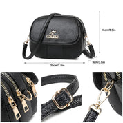 Borsa a tracolla in pelle nera con dettagli dorati, dimensioni 20x15x9 cm, chiusura a zip, design elegante e compatto, ideale per donna.
