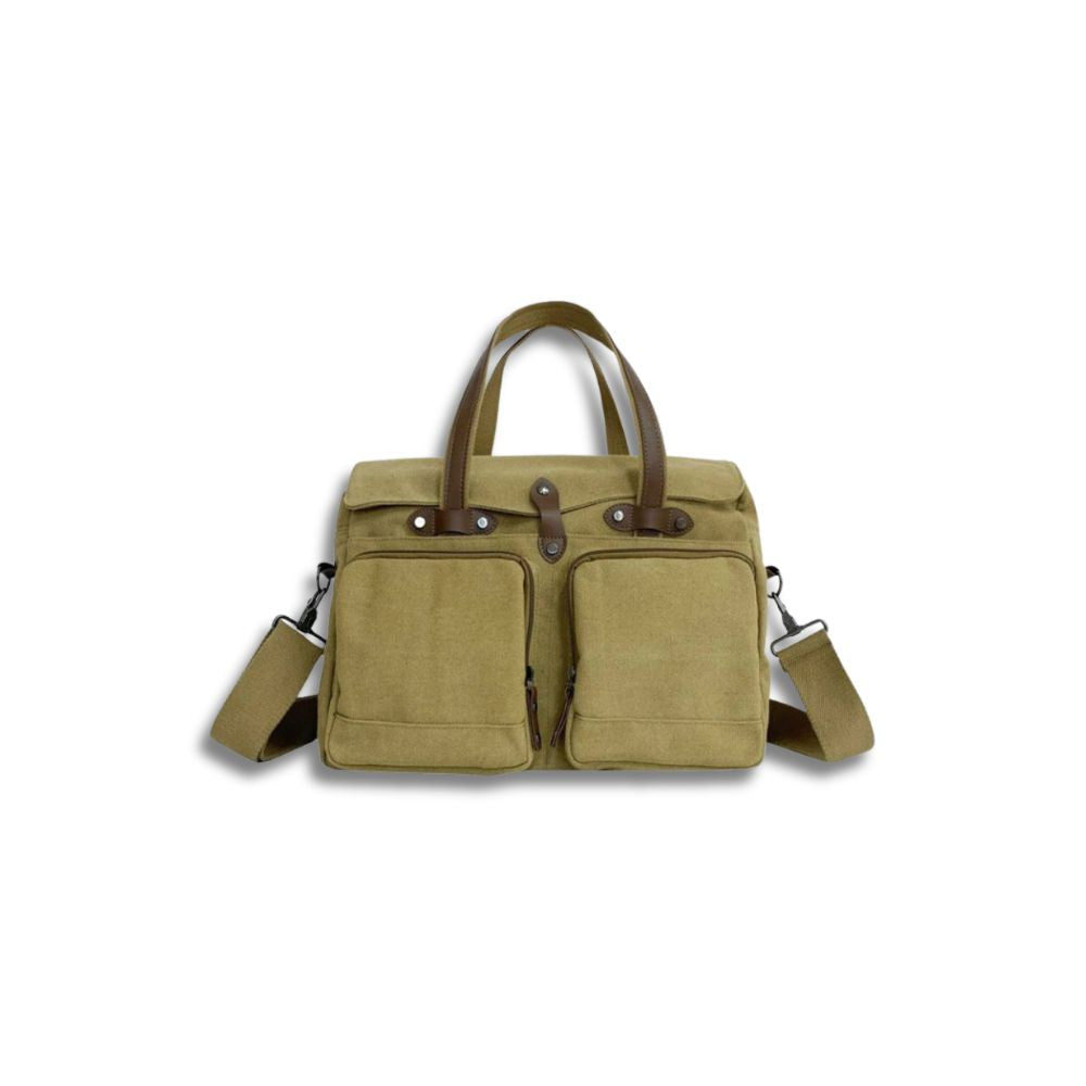 Borsa a tracolla in tela beige con manici in pelle marrone, tasche frontali con zip, ideale per lavoro e viaggio. Accessorio moda unisex.