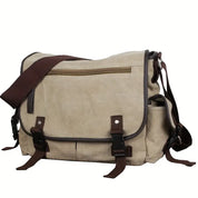 Borsa a tracolla in tela beige con dettagli in pelle marrone, tasca frontale con zip, chiusure a fibbia. Ideale per lavoro e viaggio.