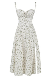 Abito estivo bianco a fiori verdi, senza maniche, con spacco laterale. Vestito midi elegante, perfetto per occasioni casual e formali.