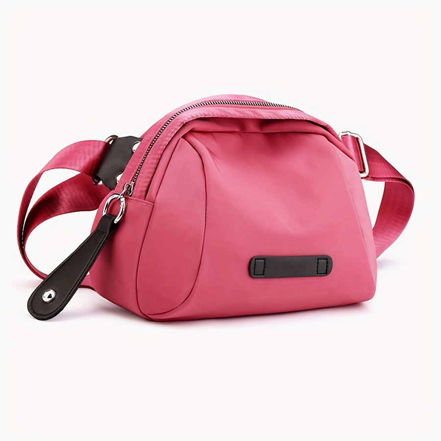 Borsa a tracolla rosa in tessuto, design moderno, con cerniera e dettagli in pelle nera. Accessorio moda donna, elegante e pratico.