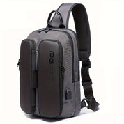 Zaino monospalla grigio scuro, design moderno, con tasche multiple e porta USB integrata. Ideale per viaggi, lavoro e uso quotidiano.
