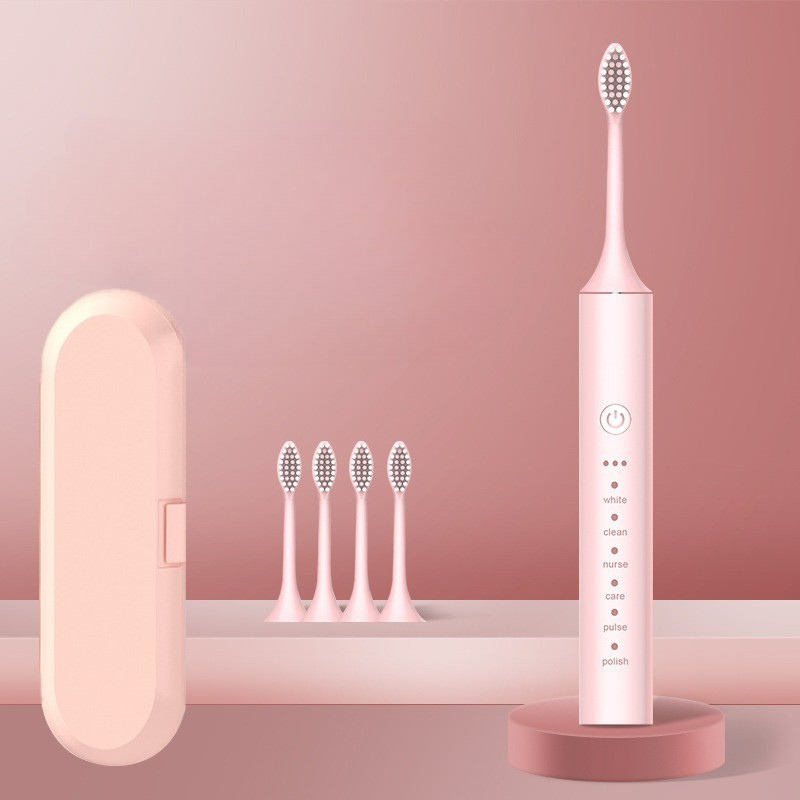 Spazzolino elettrico rosa con custodia e quattro testine di ricambio, design elegante, ideale per igiene orale avanzata e cura dentale quotidiana.