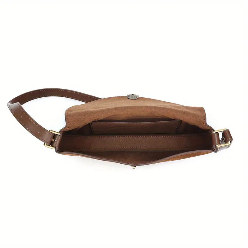 Borsa a tracolla in pelle marrone, vista dall'alto, con scomparto interno spazioso. Accessorio moda elegante e pratico per donna.