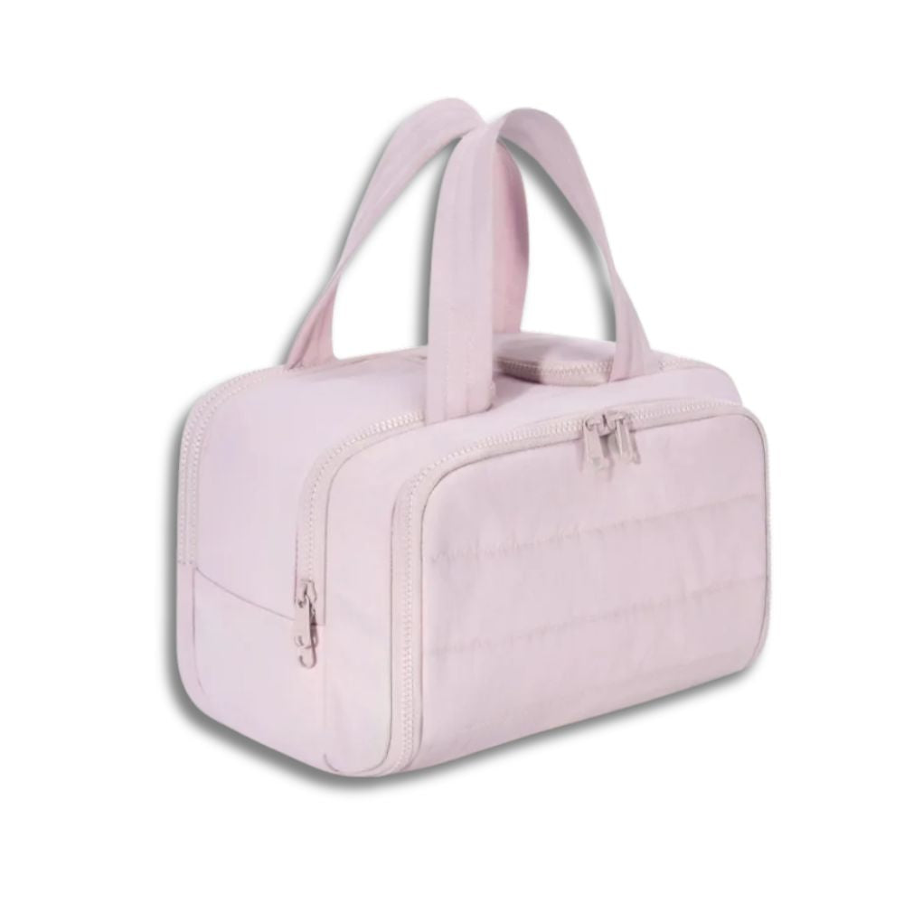 Borsa da viaggio rosa chiaro con doppia cerniera e manici, design elegante e compatto, ideale per viaggi e uso quotidiano.