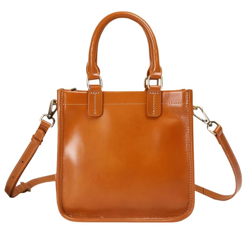 Borsa a mano in pelle marrone con tracolla regolabile, design elegante e moderno, perfetta per l'uso quotidiano e occasioni speciali.