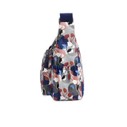 Zaino monospalla floreale multicolore, tasche laterali elastiche, design moderno, ideale per moda donna, accessori viaggio, stile casual.