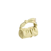 Borsa a mano in pelle gialla con manico annodato, design elegante e moderno. Accessorio moda donna, perfetto per look estivi e casual chic.