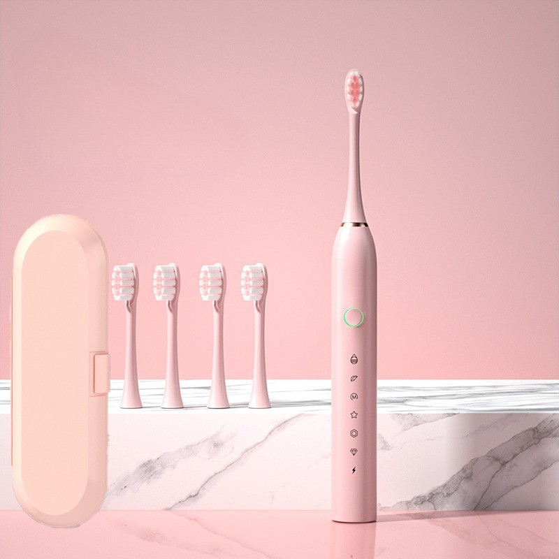 Spazzolino elettrico rosa con cinque testine di ricambio, custodia da viaggio, design elegante, set igiene orale, bagno moderno.