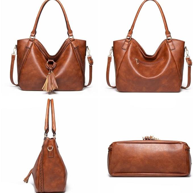 Borsa a mano in pelle marrone con nappine, tasca frontale con zip, manici robusti e tracolla regolabile. Design elegante e versatile per ogni occasione.