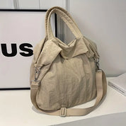 Borsa a tracolla beige in tessuto morbido, design casual con manici e tracolla regolabile. Perfetta per uso quotidiano e shopping.