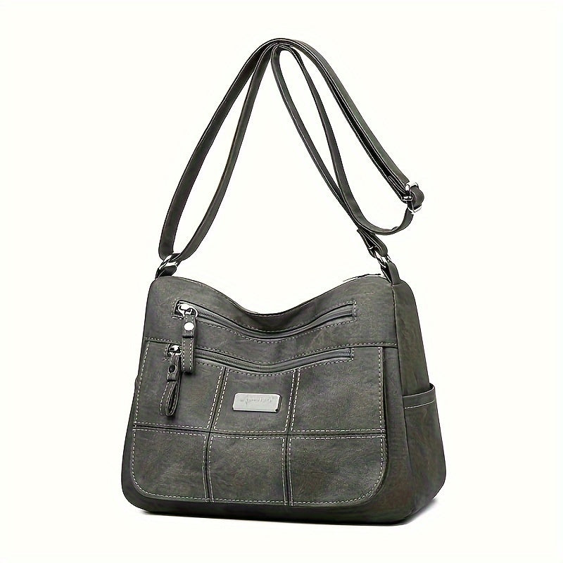 Borsa a tracolla in pelle sintetica grigia con tasche multiple e cerniere, design elegante e funzionale, ideale per uso quotidiano e lavoro.