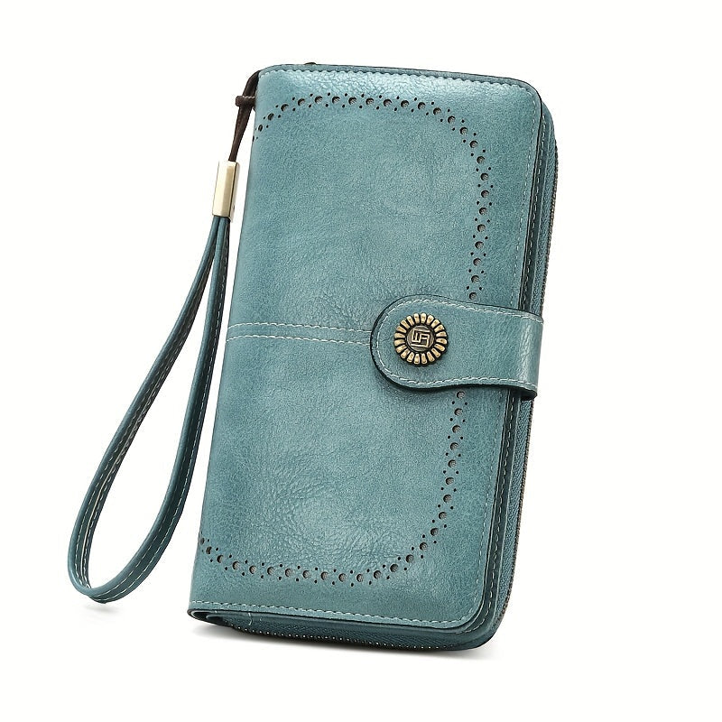 Portafoglio donna in pelle blu con cinturino da polso, chiusura a bottone decorata, design elegante e spazioso, ideale per moda e praticità.