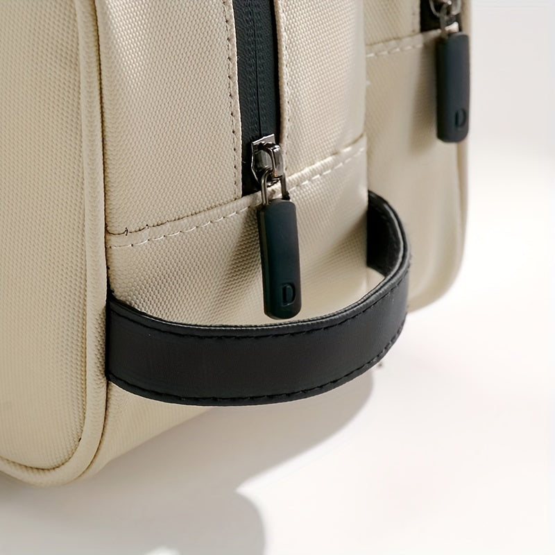 Borsa a tracolla beige con cerniere nere, manico in pelle nera, design elegante e moderno, ideale per moda e accessori di tendenza.