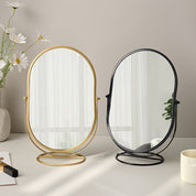 Specchio da tavolo ovale con cornice dorata e nera, design moderno, riflesso chiaro, decorazione elegante per camera da letto o bagno.