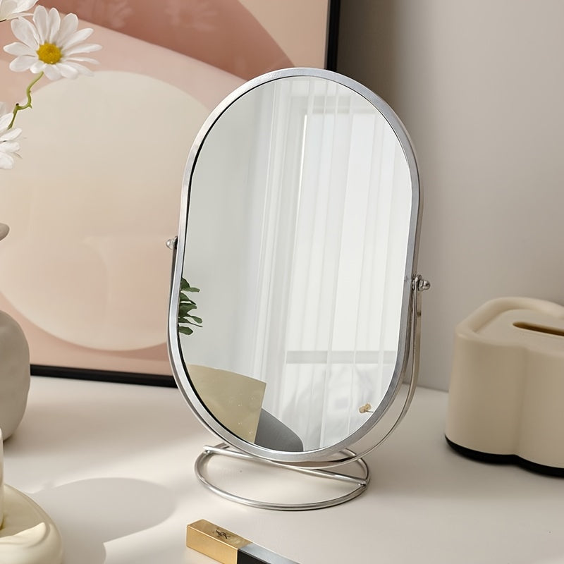 Specchio da tavolo ovale con cornice in metallo, riflesso di interni moderni, decorazione minimalista, luce naturale, vaso con margherite.