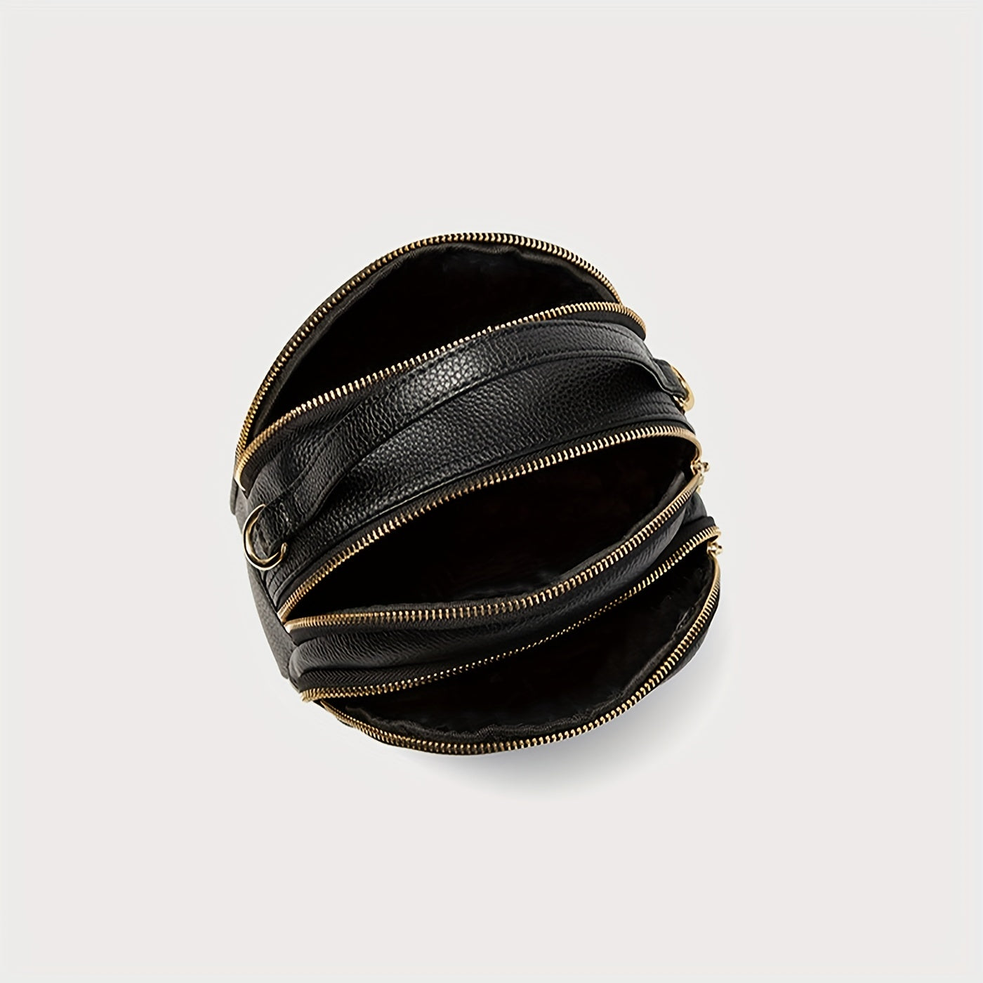 Borsa a tracolla nera in pelle con cerniere dorate, design moderno e unico, accessorio moda elegante per donna, perfetta per ogni occasione.