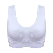 Reggiseno sportivo bianco senza cuciture, design a canotta, supporto confortevole, ideale per fitness e yoga. Materiale traspirante ed elastico.