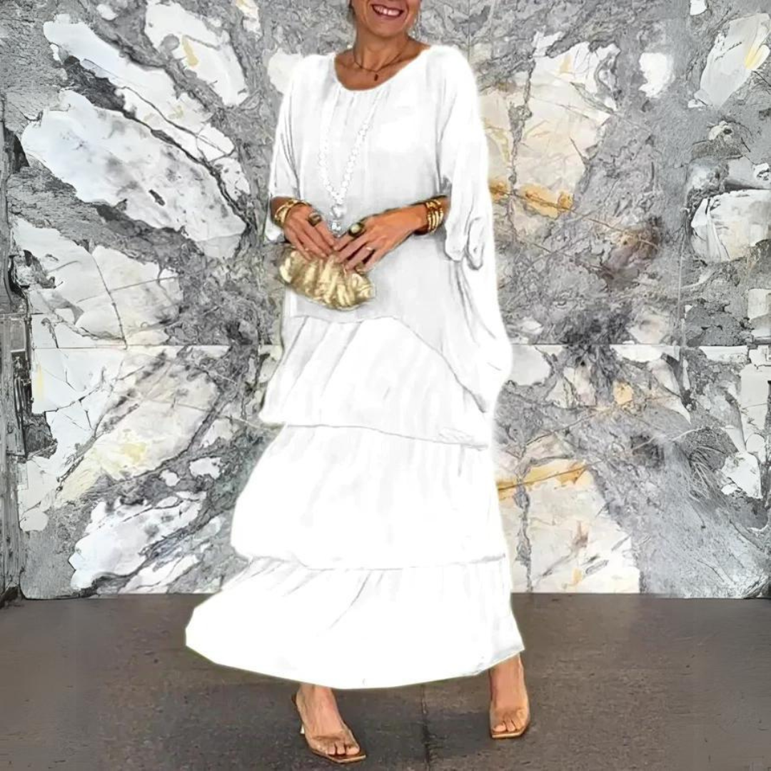 Abito bianco lungo elegante, donna con borsa dorata, sfondo marmo artistico. Moda femminile, abbigliamento estivo, stile sofisticato.