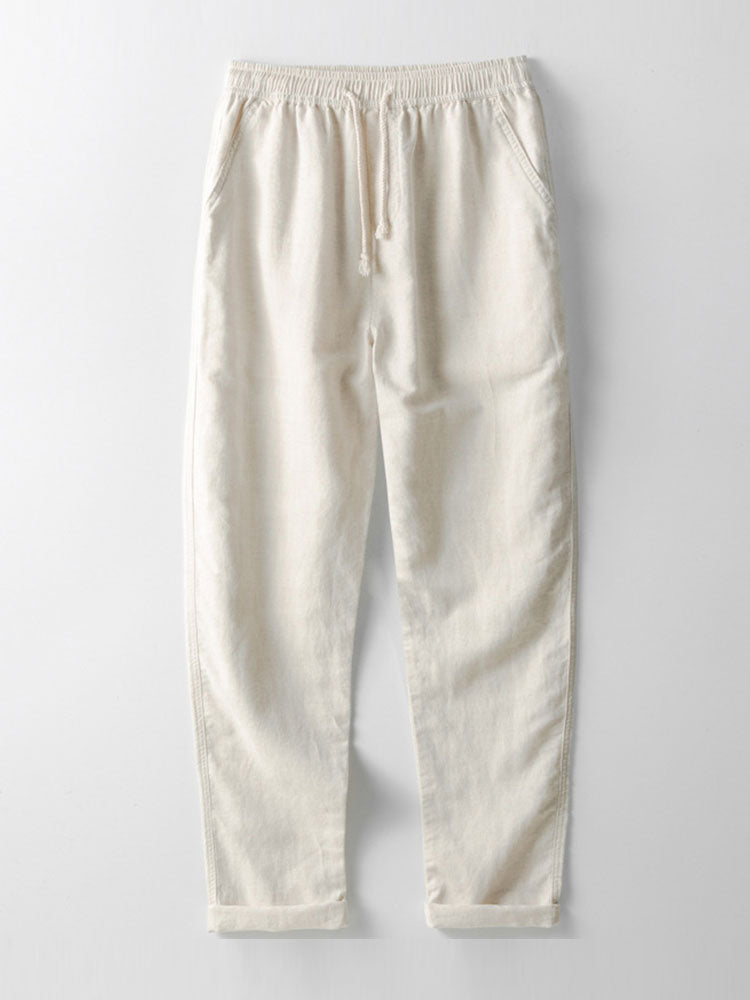 Pantaloni jogger bianchi in cotone, elastico in vita con coulisse, tasche laterali, design casual e comodo, ideale per abbigliamento quotidiano.