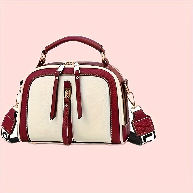 Borsa a tracolla in pelle bianca e rossa con manico superiore, cerniera dorata e tracolla regolabile. Design elegante e moderno.