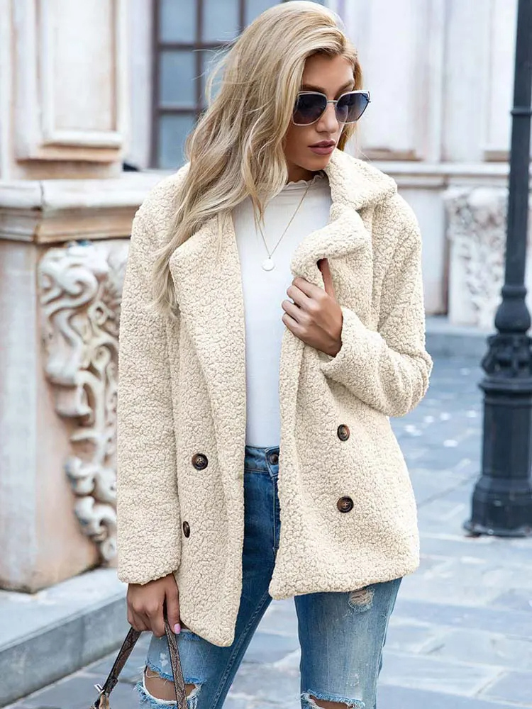 Donna con cappotto in lana beige, occhiali da sole, jeans strappati, maglia bianca, in strada urbana. Moda autunnale, stile casual chic.
