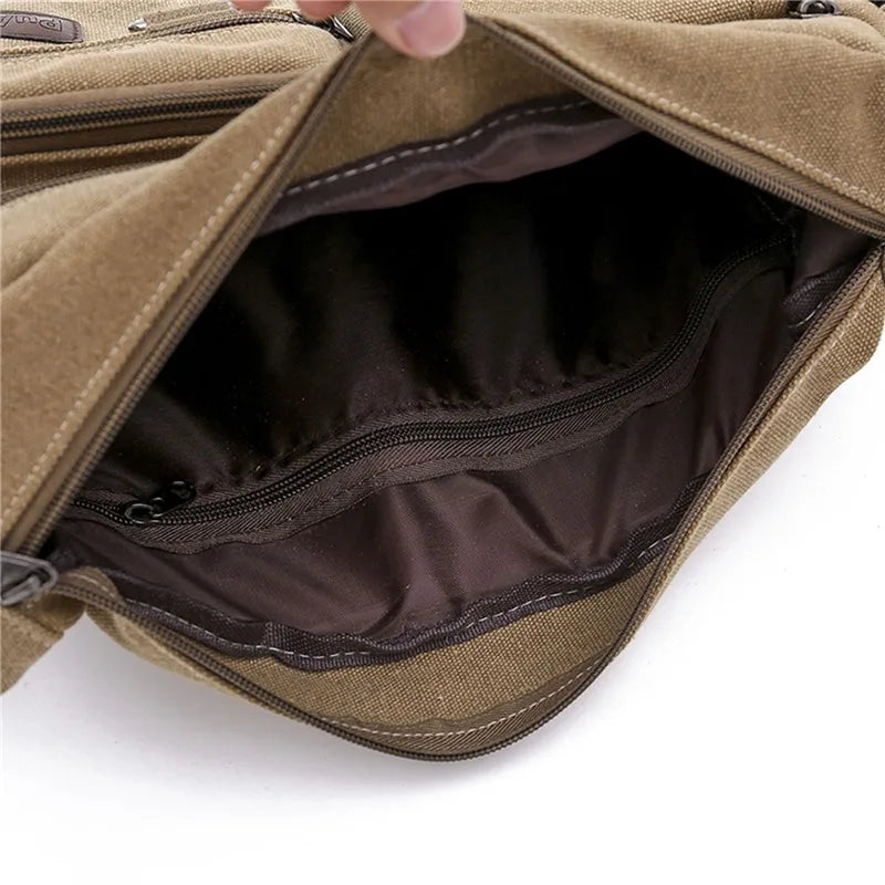 Borsa a tracolla in tela marrone aperta, con scomparto interno foderato e tasca con cerniera, ideale per uomo e donna, moda casual e resistente.