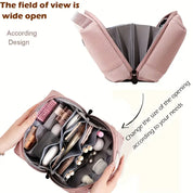 Borsa organizer da viaggio rosa aperta, design espandibile, scomparti multipli per cosmetici e accessori, ideale per viaggi e organizzazione.