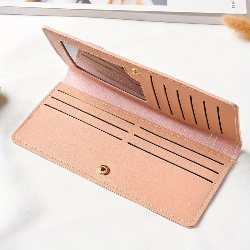 Portafoglio donna in pelle rosa chiaro con chiusura a bottone, scomparti per carte di credito e finestra trasparente, elegante e funzionale.