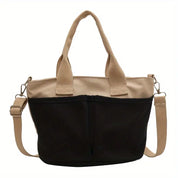 Borsa a tracolla donna in tela nera e beige, design casual, manici robusti, tasche frontali, ideale per shopping e uso quotidiano.