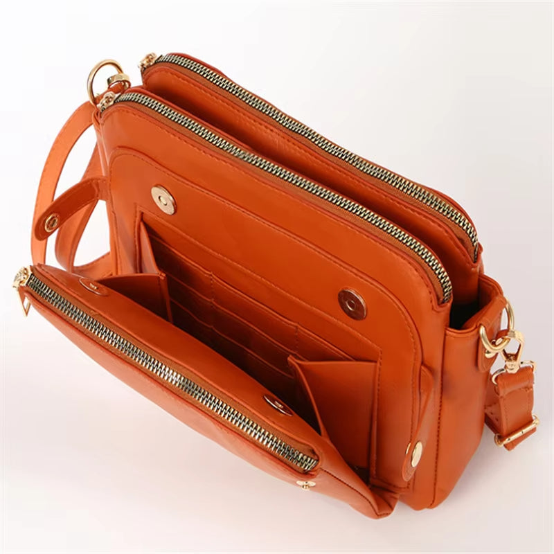Borsa a tracolla in pelle arancione con cerniere dorate, tasche multiple e tracolla regolabile. Design elegante e funzionale per donna.