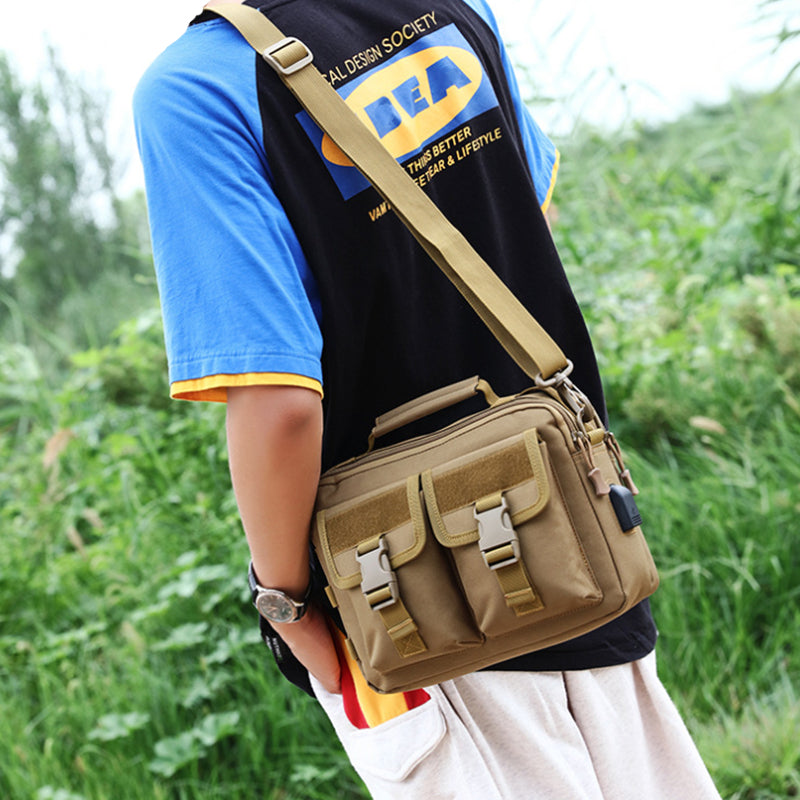 Borsa a tracolla uomo in tela marrone, stile casual, con tasche multiple e fibbie, ideale per viaggi e uso quotidiano. Accessorio moda versatile.